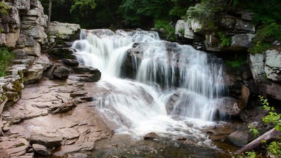 Cascading Waterfall in Forest Rocks
