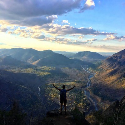 Man arms outstretched mountain overlook