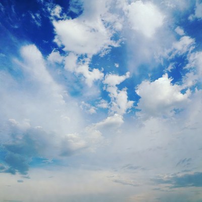 Fluffy White Clouds in Blue Sky
