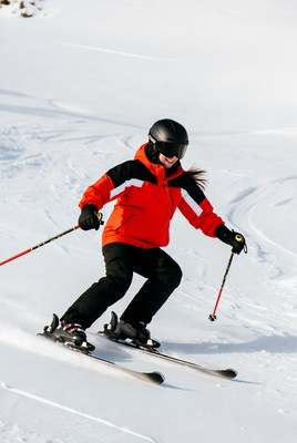Woman skiing down snowy slope