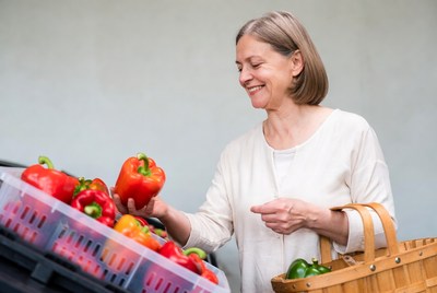 Senior woman selecting bell peppers