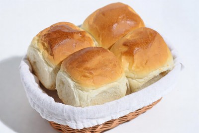 Fresh bread rolls in white basket