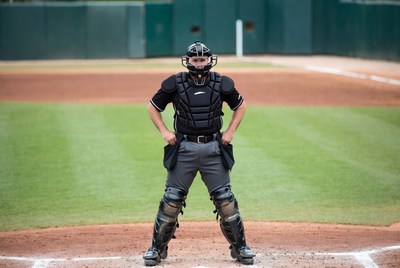 Baseball catcher standing on field
