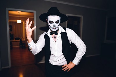Man in skeleton face paint waving