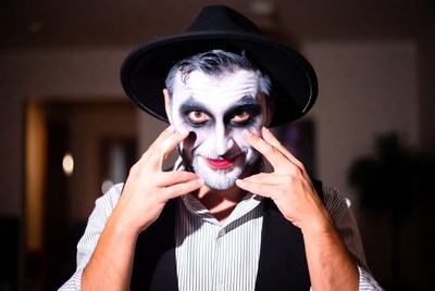 Man in Joker makeup with hat