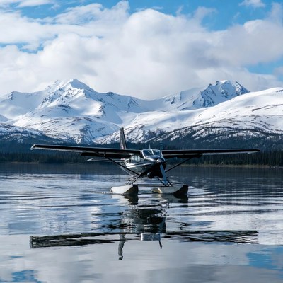 Seaplane on lake with snowy mountains