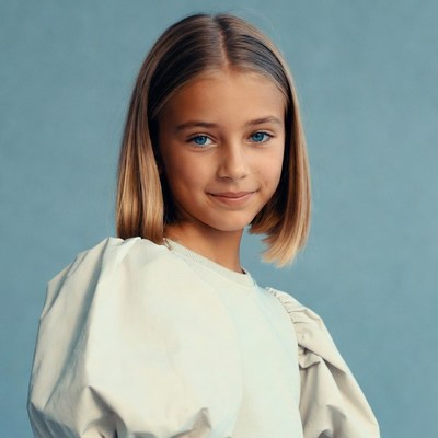 Smiling girl in puffy sleeve sweater