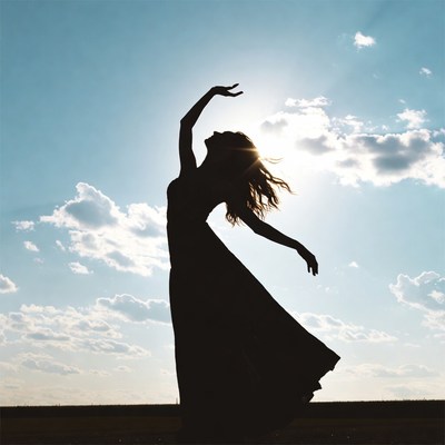 Woman dancing silhouette against sunset
