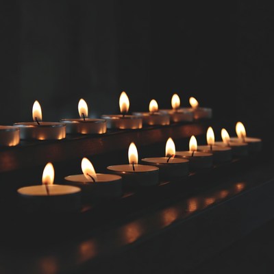 Row of lit candles on stand