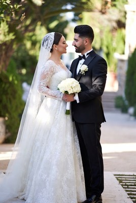 Bride and groom in garden archway