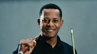 African-American man holding pool cue