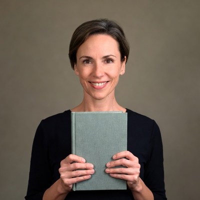 Woman holding green book