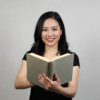 Asian woman holding open book