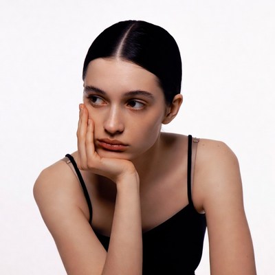 Woman resting chin on hand