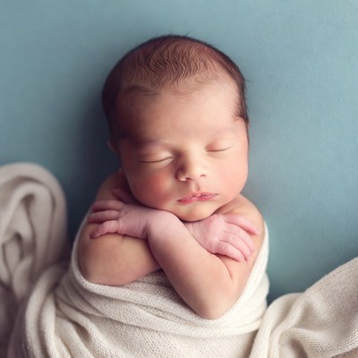 Newborn baby sleeping swaddled