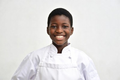 African boy chef smiling in white uniform