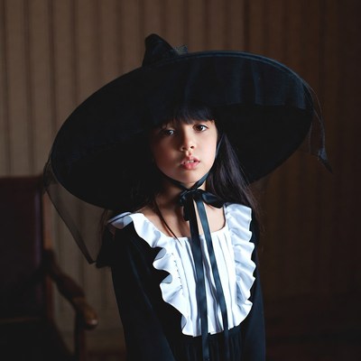 Girl wearing large black witch hat