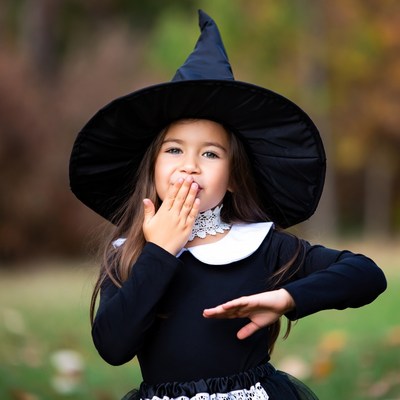 Girl in witch costume gasping surprised