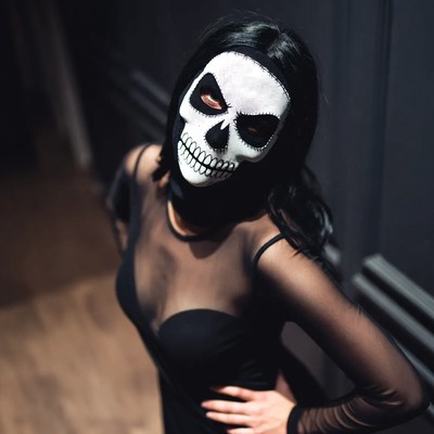 Woman in skull mask costume