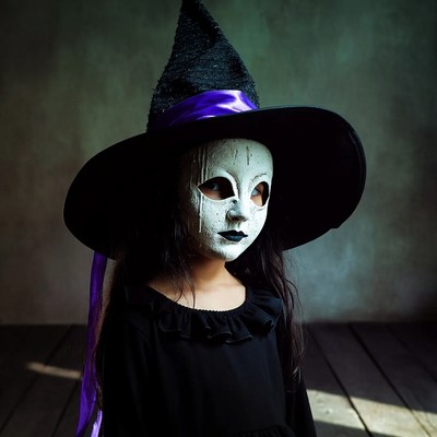Girl in witch mask and hat