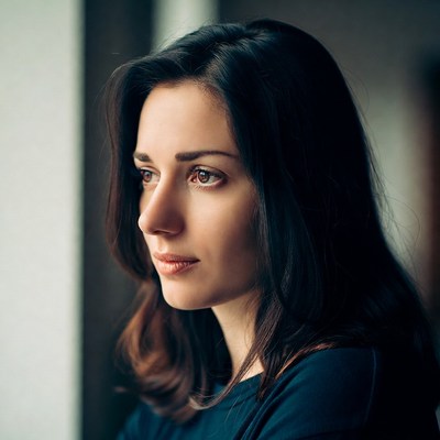 Woman gazing thoughtfully by window
