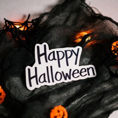 Happy Halloween sign on spider web