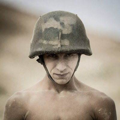 Man wearing camouflage helmet