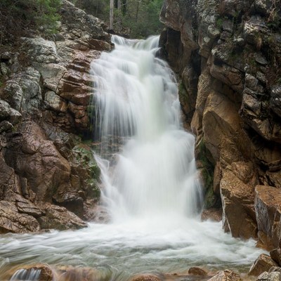 Cascading Waterfall in Rocky Forest
