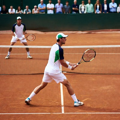 Tennis player serving on clay court