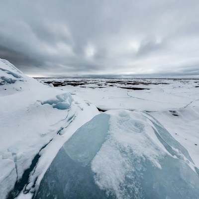 Icy glacier overlooking snowy tundra