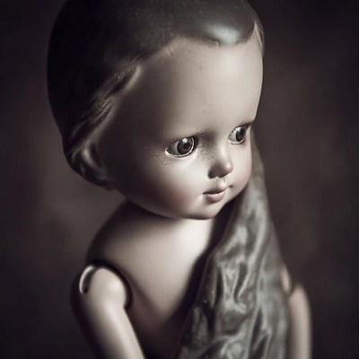 Vintage doll with cloth draped over