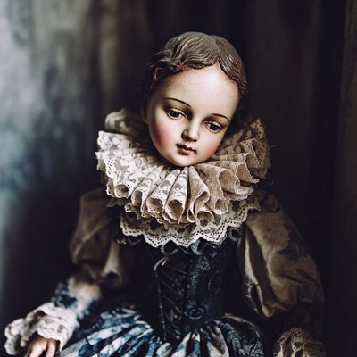 Porcelain doll in vintage lace dress