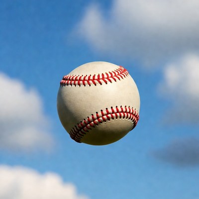 Baseball flying against blue sky