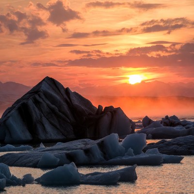 Sunset over iceberg-filled Arctic waters