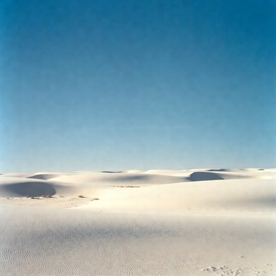 White Sand Dunes Under Blue Sky