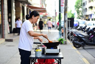 Asian woman cooking street food