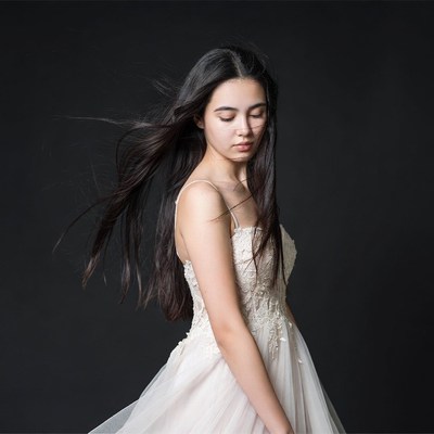 Young woman in flowing white gown