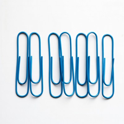Blue paper clips on white background