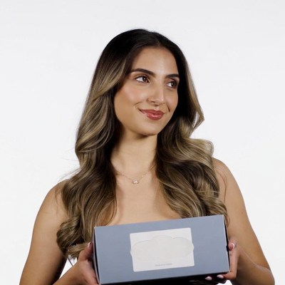 Woman holding gray gift box