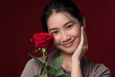 Asian woman holding red rose