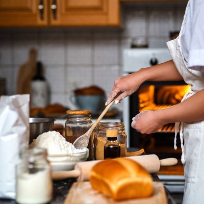Woman baking bread in kitchen