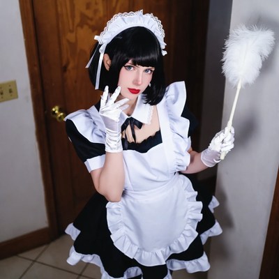 Woman in maid costume holding feather duster