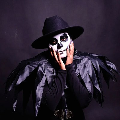 Man in sugar skull makeup with hat