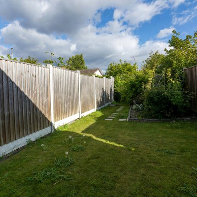 Garden path between wooden fences