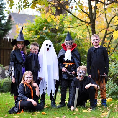 Group of Children in Halloween Costumes Outdoors