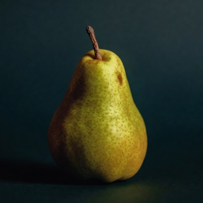 Green pear on dark background