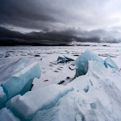 Icebergs on Arctic Sea Under Stormy Sky