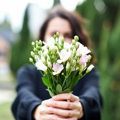 Woman holding pink flowers