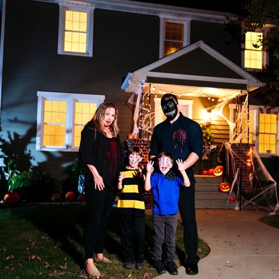 Family in Halloween costumes on porch
