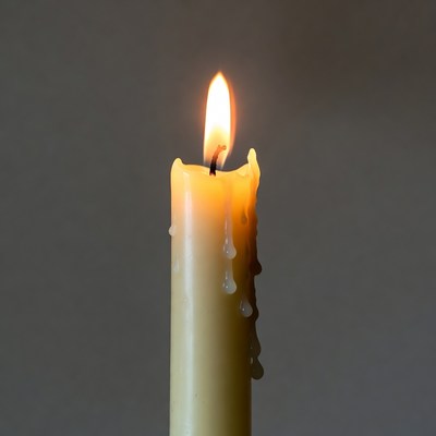Burning Candle with Dripping Wax